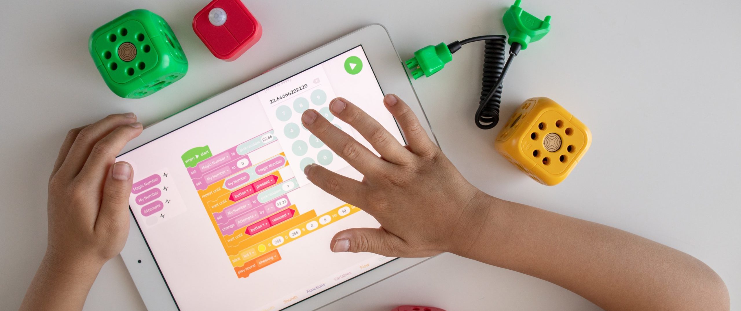 person holding white ipad on white table